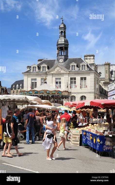 A young woman carrying a child before Auray market in Brittany, France Stock Photo - Alamy