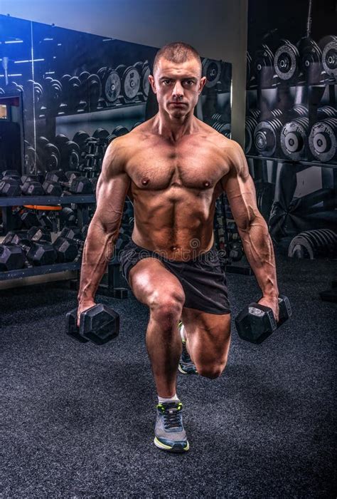 Lunges with dumbbells stock photo. Image of powerful - 150663236