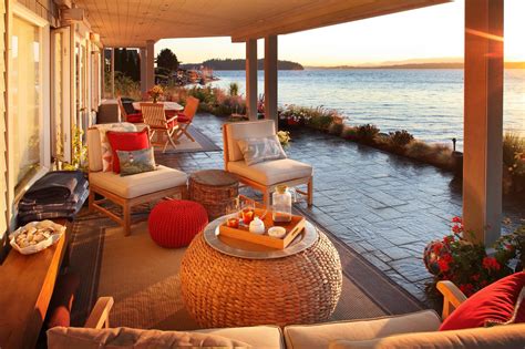 Covered Waterfront Patio With Stone Floor And Woven Ottoman #49978 | House Decoration Ideas