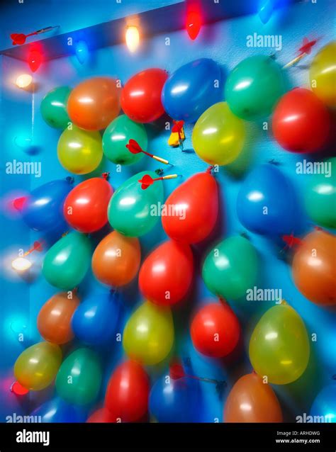 dart balloon game at carnival Stock Photo - Alamy