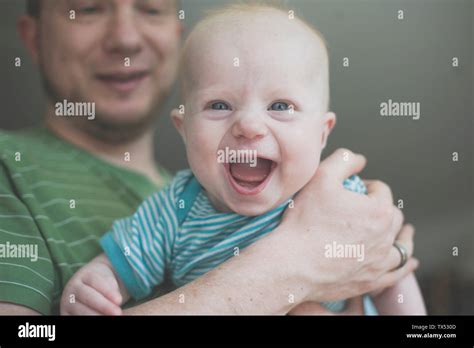 Father holding his laughing baby daughter Stock Photo - Alamy