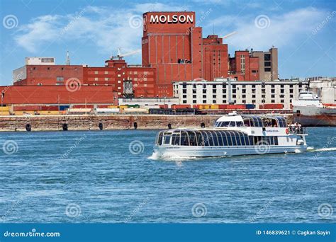 Historical Molson Brewery Building and a Tour Boat on Saint Lawrence River in Montreal, Quebec ...