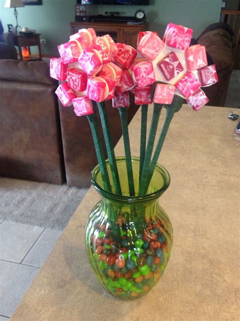 Valentine's Day Candy Bouquet: What you need: Wood sticks (I used 1/4x1/4 ones) Wooden flower ...