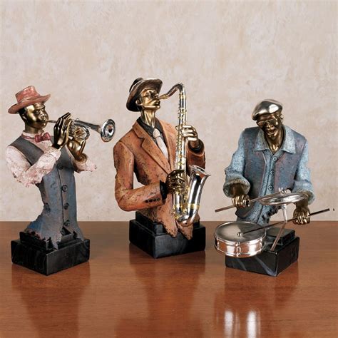 three figurines sitting on top of a wooden table next to a silver pan