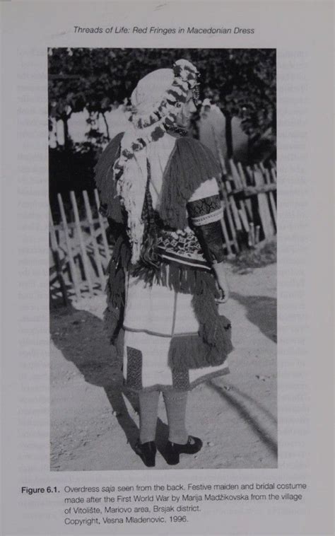 an old black and white photo of a woman wearing a hat with feathers on it