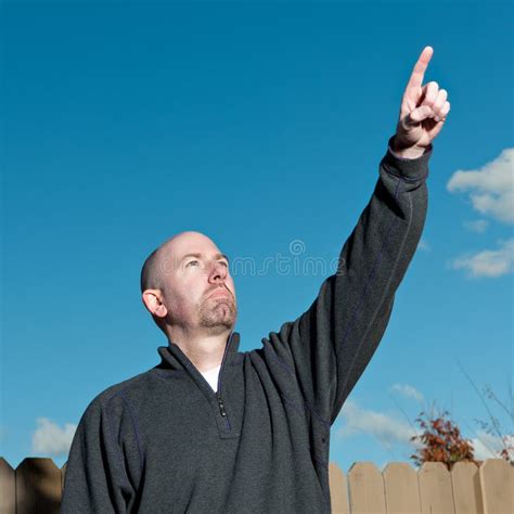 Man Pointing to the Sky stock photo. Image of raised - 22082966