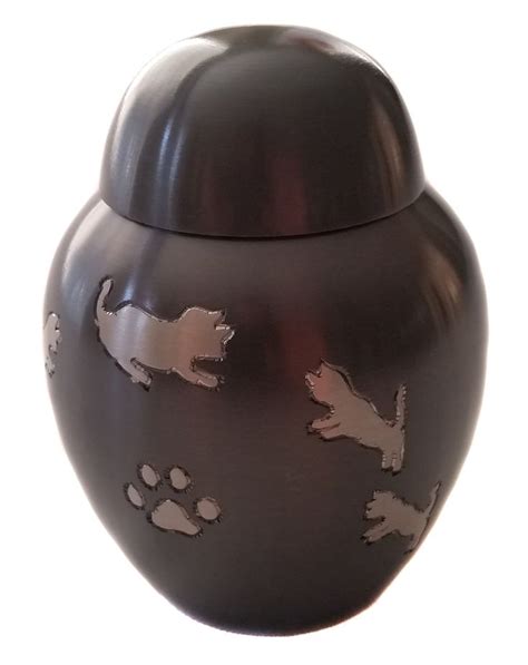 a black urn with cats on it and paw prints painted on the outside side