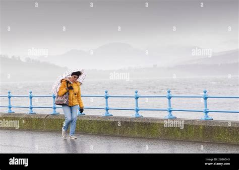 Greenock, Scotland / UK - February 20th 2020: People walking along coastal path during Storm ...