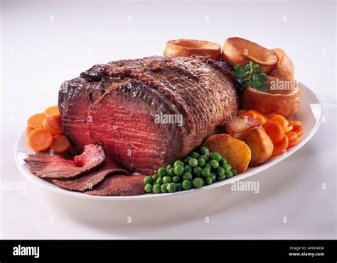 Roast beef Yorkshire pudding roast potatoes and peas Stock Photo - Alamy