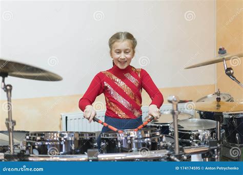 Teen Girl Playing the Drums. Teen Girls are Having Fun Playing Drum Sets in Music Class Stock ...