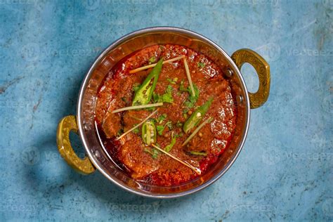 Spicyy mutton karahi masala with napkin isolated on wooden table top ...