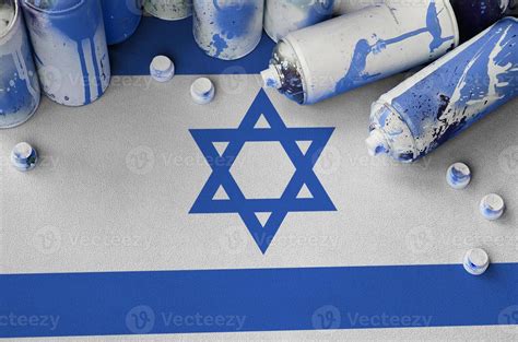 Israel flag and few used aerosol spray cans for graffiti painting ...