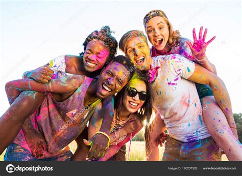 Happy friends at festival of colors Stock Photo by ©ArturVerkhovetskiy ...