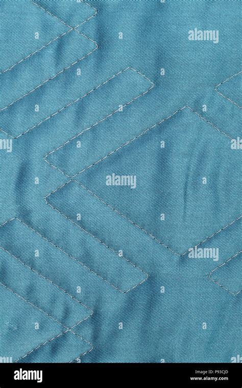 Cyan quilted fabric texture with geometric pattern Stock Photo - Alamy