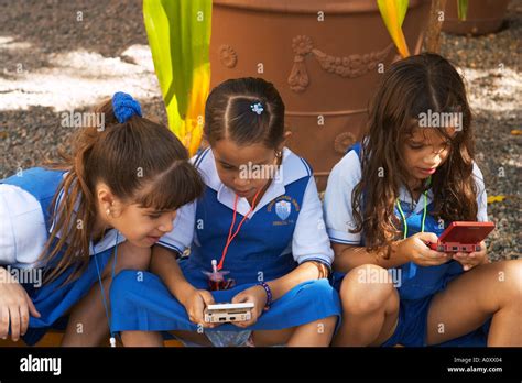 PUERTO RICO San Juan Young girls wearing school uniforms play outdoors ...