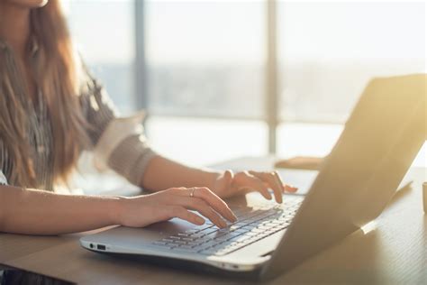 Female writer typing using laptop keyboard at her workplace in the ...