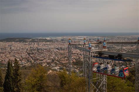 Aerial Shot of the Tibidabo Sky Walk with a Cityscape of Barcelona with Blocks and a Sea in ...