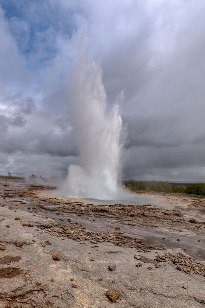 Premium Photo | Vertical shot of an exploding geiser in iceland