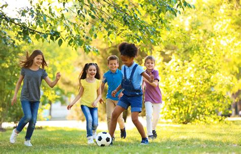 Cute little children playing with ball outdoors on sunny day ...