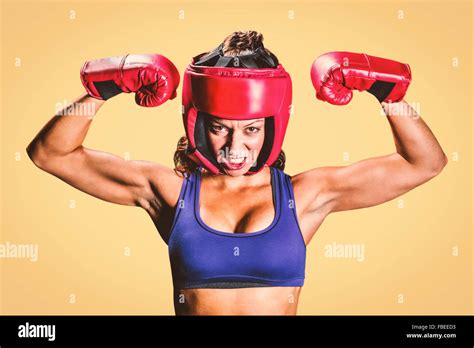 Composite image of portrait of angry female boxer flexing muscles Stock ...