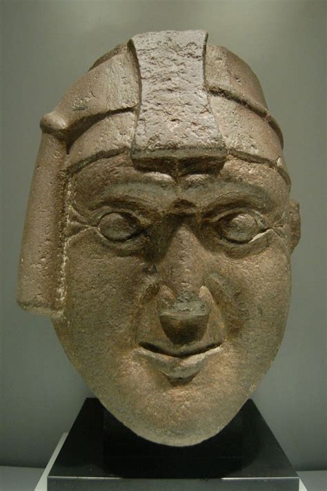 an ancient head is on display in a museum