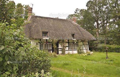 Traditional thatched roof cottage — Stock Photo © theclarkester #12718864