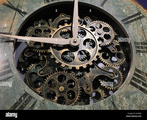 Cogs in a clock Stock Photo - Alamy