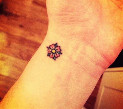 Pink Ink Little Daisy Flower Tattoo On Wrist | Flower wrist tattoos, Simple hand tattoos, Small ...