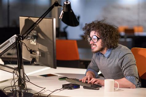 man working on computer in dark startup office 12134426 Stock Photo at ...