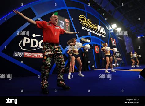 Peter Wright gestures to the crowd as he arrives on stage after his walk on during day two of ...