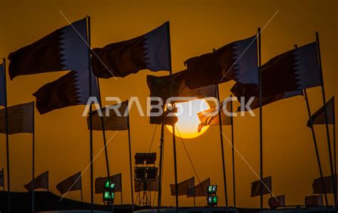 Flags of the State of Qatar, the Qatari national flag flying high, the ...