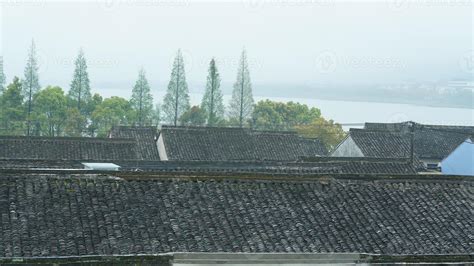 The beautiful Chinese countryside village view with the old traditional buildings surrounded by ...