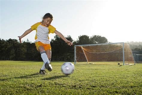 A young girl playing soccer on a soccer field in Los Angeles, California. stock photo