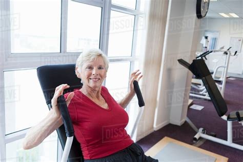 Older woman exercising in gym - Stock Photo - Dissolve