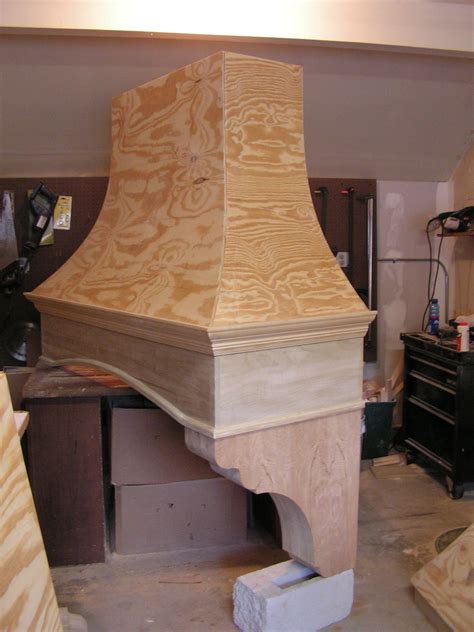 a wooden stove top sitting on top of a table in a room filled with furniture