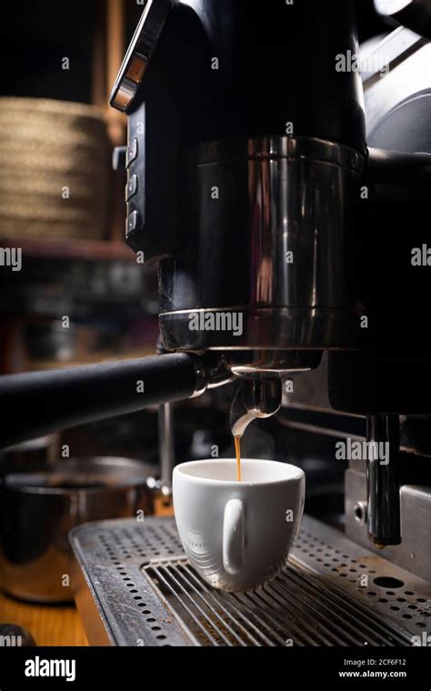 Barista making coffee using a coffee maker Stock Photo - Alamy