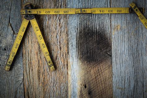 Old Tape Measure for Construction on Rustic Wood Background Photograph by Brandon Bourdages ...