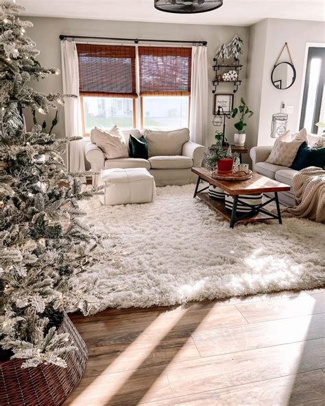 a living room filled with furniture and a christmas tree in the middle ...