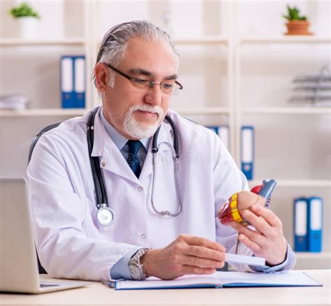 Aged Male Doctor Cardiologist with Heart Model Stock Image - Image of insurance, clinic: 276826479