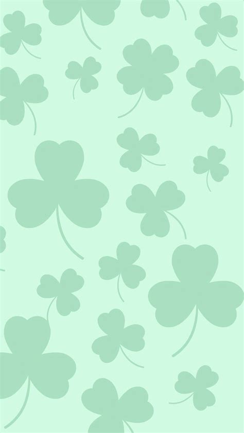 four leaf clovers on a light green background for st patrick's day wallpaper