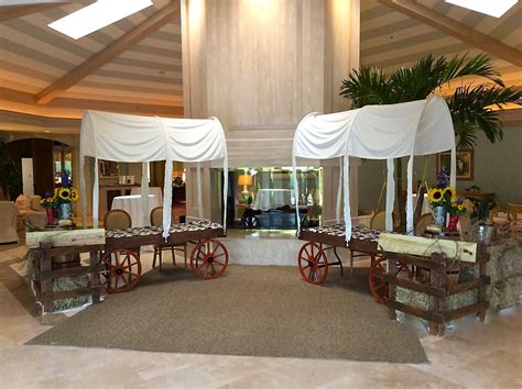 Western themed party decorations. Chuck wagon check-in tables built around a 6' banquet tables ...