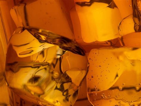 Premium Photo | Whisky on the rocks glass filled with ice cubes closeup shot