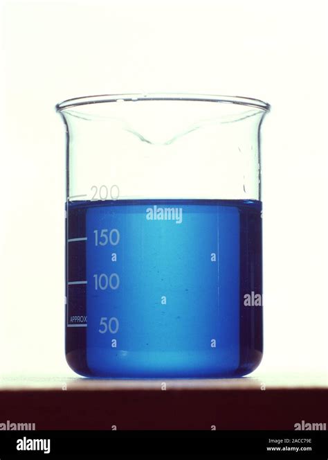 Copper sulphate solution in a beaker. Copper sulphate (CuSO4) is a salt used as a water ...