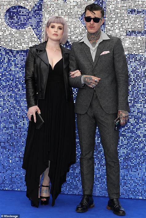 Kelly Osbourne stuns in low-cut black number while joined by boyfriend ...