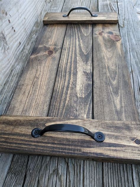 a wooden board with black handles on it