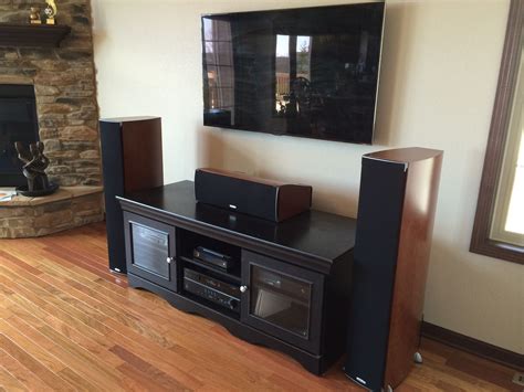 Premium home theater system with wall-mounted flat panel TV and floor standing Polk Audio ...