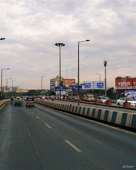 Cars on Highway with Billboards and Traffic Lights