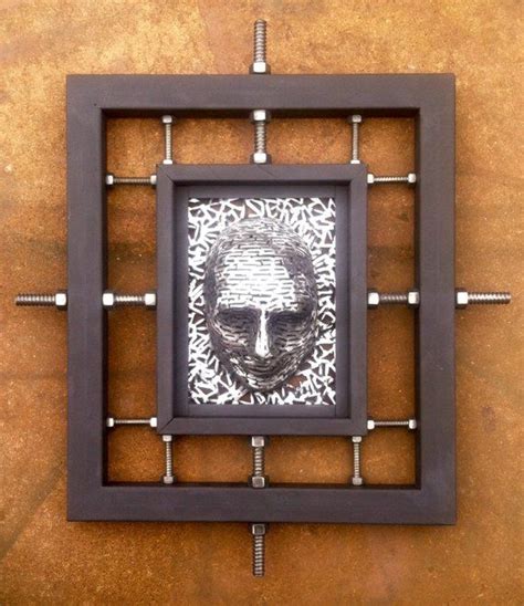 a square frame with an image of a man's face in the center and rivets on the sides