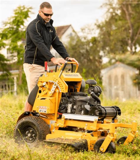 Step up onto a Hustler stand-on mower - Landscape Contractor