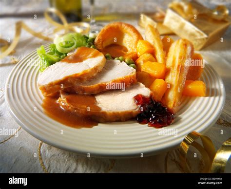 Traditional roast turkey Christmas dinner with all the trimmings and roast potatoes, plated ...